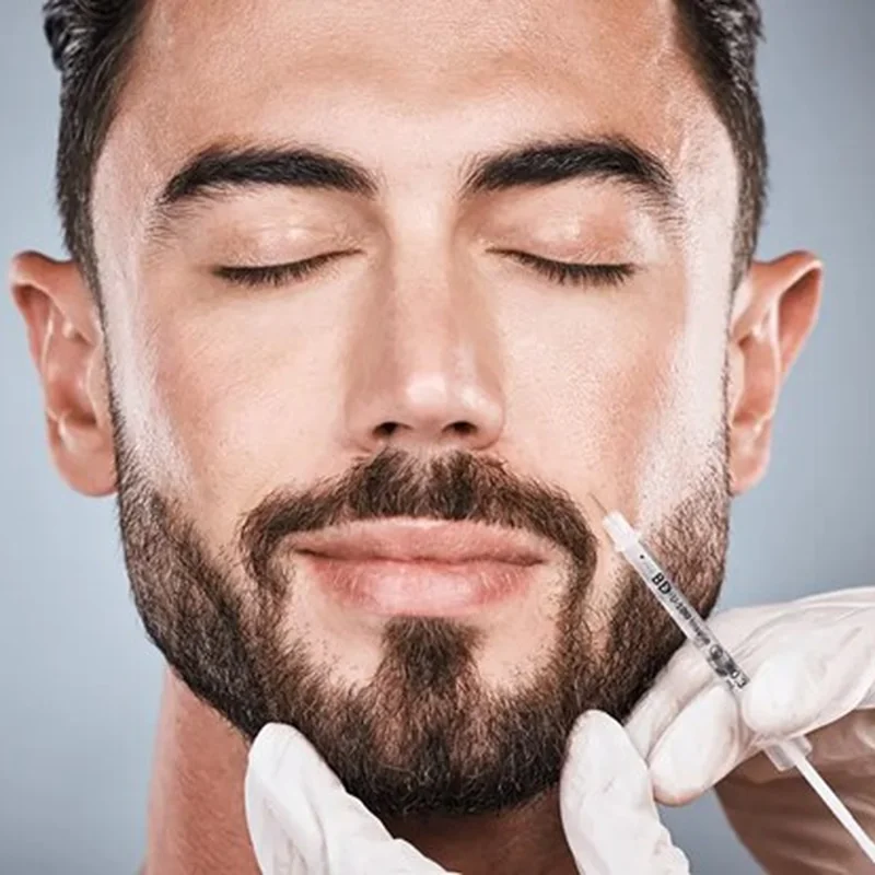 Male facial fillers in Abu Dhabi: man receiving a dermal filler injection along the jawline